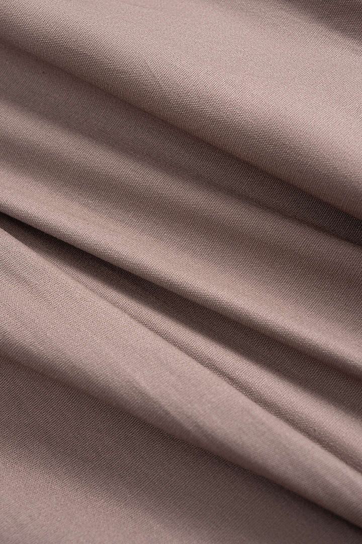 Asymetrické midi šaty s dlouhým rukávem a knoflíky